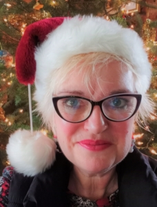 Photo of author Catriona McPherson with a Santa hat on. 